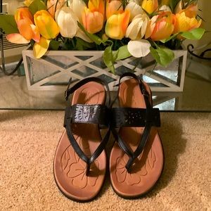 Pretty black leather thong sandals with a flower detail.  Excellent condition.